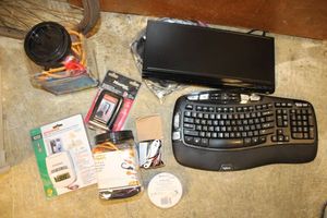 lot 127 image: Bungee cords, light timer, master lock box, Logitech keyboard, and Toshiba DVD player