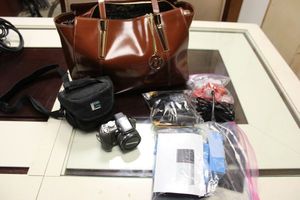 lot 153 image: Olympus camera, Ring doorbell parts, and McKlein brown leather tote bag