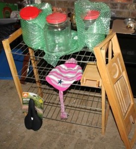 lot 99 image: Small Wire shelf unit, Bathtub tray, Mountain Bike seat, glass gallon jars, and pink Cowboys winter hat