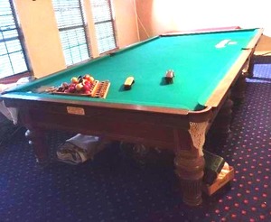 Gentleman's billiards table around 12 ft long and six and a half wide give or take with Ivory pool stick holders (bring help we will not be helping with this move) also we'll have to be broke down to be moved