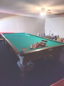 Gentleman's billiards table around 12 ft long and six and a half wide give or take with Ivory pool stick holders (bring help we will not be helping with this move) also we'll have to be broke down to be moved