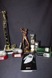 lot 35 image: Shop Awards and Gifts perpetual golf trophy with a male golfer figure, incudes a Srixon branded golf gloves and boxed golf balls&nbsp