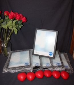 lot 46 image: Photo frames, stress ball hearts, roses and glass vase