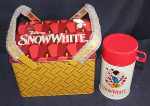 lot 51 image: Alamo Drafthouse Exclusive Snow White Apple Basket Lunchbox Set Includes thermos, Designed by Christine Smith and sold during special screenings of Snow White (2025) at Alamo Drafthouse Cinemas