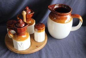 lot 109 image: McCoy style cruet set features a brown drip glaze over white stoneware base, and lazy susan