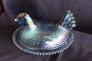 lot 104 image: Indiana Glass Iridescent Carnival Blue hen on nest covered candy dish