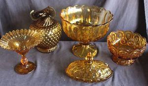 lot 107 image: Vintage Amber glass Moon and Stars pattern and Tiara Indiana Glass Vase in amber hobnail pattern with a ruffled top