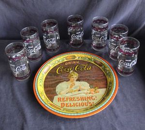 lot 115 image: Coca-Cola 75th Anniversary collection set includes a round metal serving tray and seven matching glasses