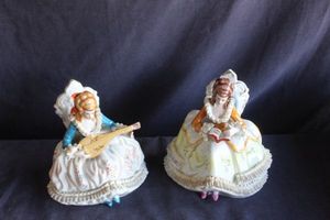 lot 118 image: Vintage Porcelain Figurines Featuring Victorian-style ladies seated in chairs, known for their elaborate Dresden-style ruffled lace dresses.