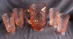 lot 121 image: Vintage Indiana Glass Pitcher and tumbler set in the whitehall or cubist pattern in distinct pink color often described as peach-pink or amber-pink
