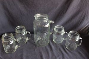 lot 128 image: Golden Harvest Mason Jar set, featuring a 48oz glass pitcher and four 1 pint drinking mugs with handles.