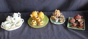 lot 130 image: Four Miniature resin and porcelain tea sets