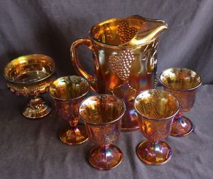 lot 135 image: Indiana Glass Harvest Grape Water Set in a Marigold iridescent carnival glass finish, set includes Pitcher, 4 glasses and candy dish in Kings crossing pattern