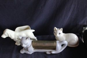 lot 138 image: Three Vintage Mid-Century Modern desk organizers,1956 Miramar California pottery cat letter or recipe featuring brass wire coils, and dog and cat organizer or planter.
