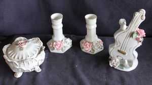 lot 139 image: Capodimonte style porcelain trinket box with floral lid, two candle holders and musical instrument shaped figurine