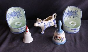 lot 147 image: Delft Blue Cow Creamer, two candlestick holders and two bells