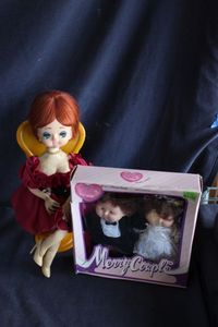 lot 460 image: Vintage Marry Couple Dolls SIP and A Senpo Tokyo Japan Big Eye Doll Sitting on A Spinning wind-up Musical Chair