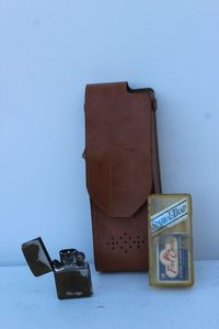 lot 465 image: Leather Walkie Talkie Case, Vintage Zippo , and Strike anywhere Matches