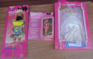 lot 294 image: Barbie- sparkle beach outfit, key chain and bridal gown