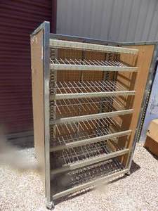 lot 27 image: 4 foot display rack shelves on one side peg boards with hook son another