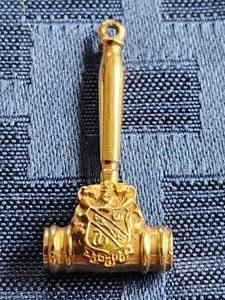 lot 42 image: Gold gavel charm - research says it is 10 gold - 4 grams