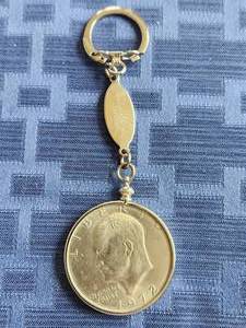 lot 98 image: Dwight Eisenhower key chain fob with 1972-dollar coin