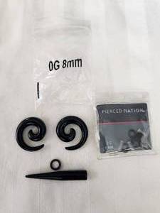 lot 179 image: Selection of acrylic black spiral and cone ear expander