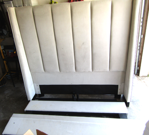 lot 576 image: Living Spaces queen bed plush head board, rails, and foot board with support rails