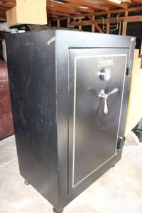 Sentinel gun safe (contents not included) Weighs 800 lbs. Bring equipment and help to remove! Has key and you can reprogram the combination.