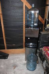 lot 133 image: Avalon water dispenser, features water jug storage under cabinet with hot and cold water