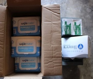 lot 207 image: Flushable wipes, alcohol wipes, and Lube packets
