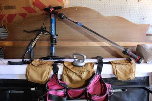 lot 209 image: Misc. tools LED work light, tool belts, air pump, bow, and dent puller