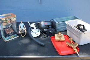 lot 214 image: Misc. lot ammo shell sculptures, gator head, action figures, security camera