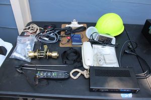 lot 202 image: Hard hat, electronics, and doorknob