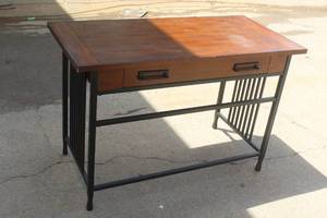 lot 75 image: Leick Home Ironcraft 46-inch writing desk features a mission oak finish and a matte black steel base.