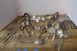 lot 100 image: mixed lot of vintage silver-plated flatware, including various spoons, forks, and knives