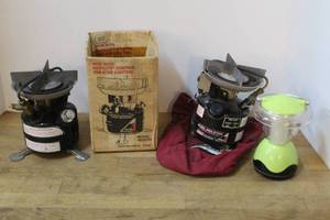 lot 173 image: 2-vintage Coleman Peak 1 Model 400A single-burner backpacking stove and a light