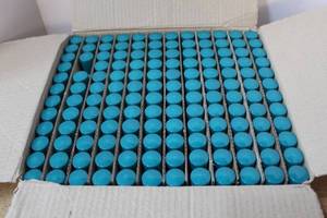 lot 206 image: Box full of travel size Sweet Bouquet moisturizing lotion. Over 100 in box