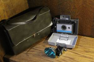 lot 174 image: vintage Polaroid Automatic 210 Land Camera with a plastic body and a blue-accented front plate
