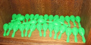 lot 201 image: collection of small, bright green plastic  Maracas