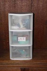 lot 398 image: white plastic frame and three see-through drawers with contents