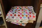 Large vintage handmade Cathedral Window pattern quilt features a multicolored desig