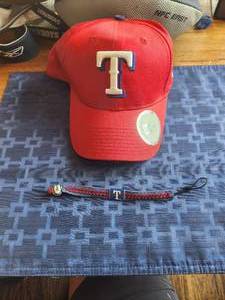 lot 77 image: Texas Rangers hat and bracelet