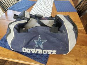 lot 145 image: Dallas Cowboys gym bag full of game Lanyards. Willie Nelson, George Strait