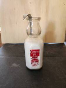 lot 204 image: Vintage Carnations glass milk and creamer bottle with creamer spoon