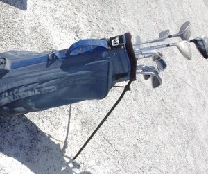 lot 180 image: Blue canvas golf bag with mixed golf clubs