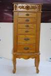 Traditional standing jewelry armoire with decorative carved scrollwork