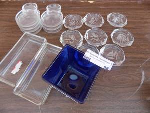 lot 98 image: Clear marine ashtrays, butter dish, vintage Fostoria coasters, and tea bag rest
