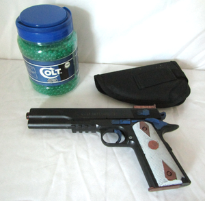 lot 523 image: Colt 45 replica pellet gun with pellets and holster