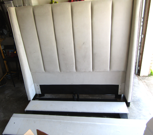 lot 599 image: Living Spaces queen bed plush head board, rails, and foot board with support rails